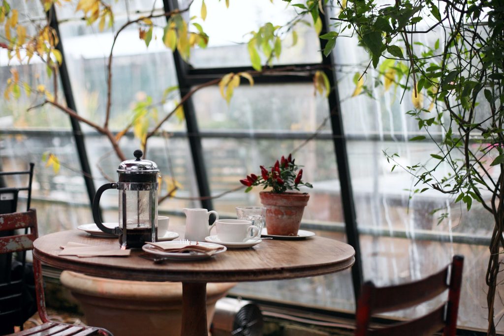 coffee press on table by the window