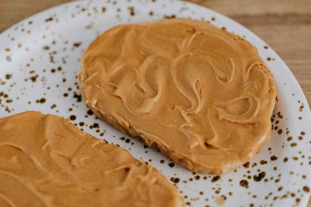 a plate with peanut butter on bread