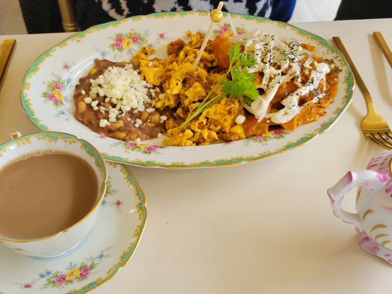 plate of chilaquiles and mexican coffee in a cup
