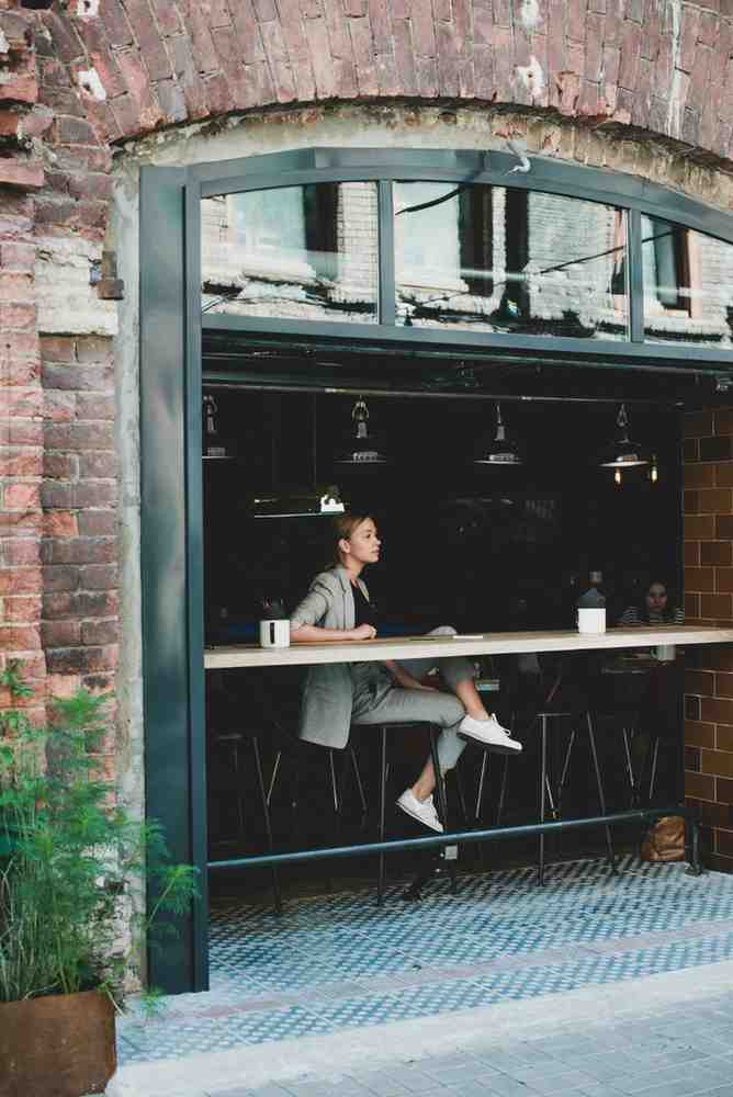 woman looking outside from a coffee shop