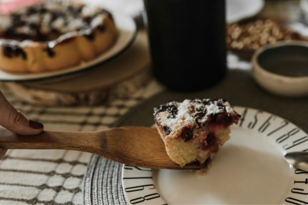 a slice of cherry cake resting on a cake server