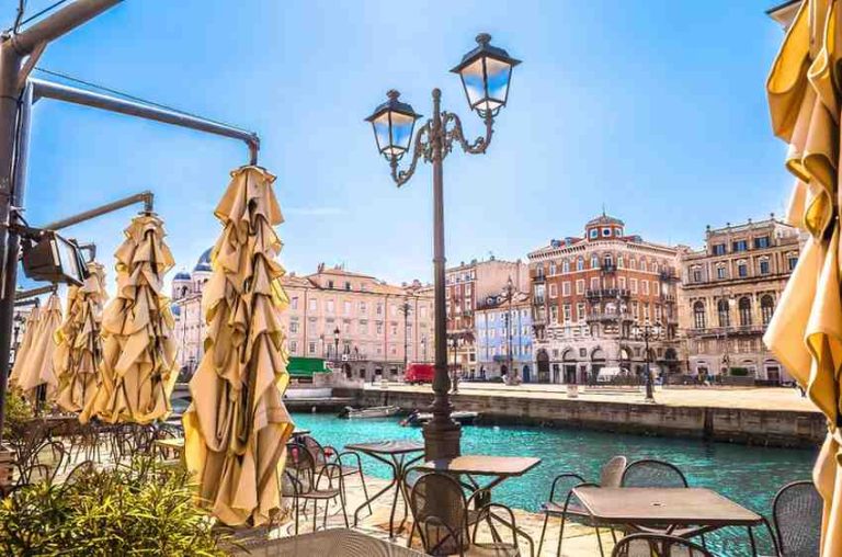 a view of a canal from an outdoor cafe in Trieste Italy